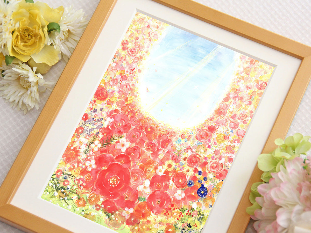たくさんの花が光へ向かって咲き広がる絵を、花とともに額装して写した写真